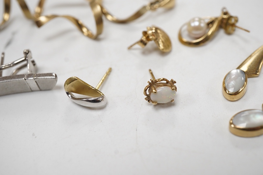 Three modern pairs of 9ct gold earrings, including spiral, triangular and moonstone set, together with five odd earrings.